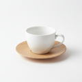White porcelain coffee cup with wood-tone saucer